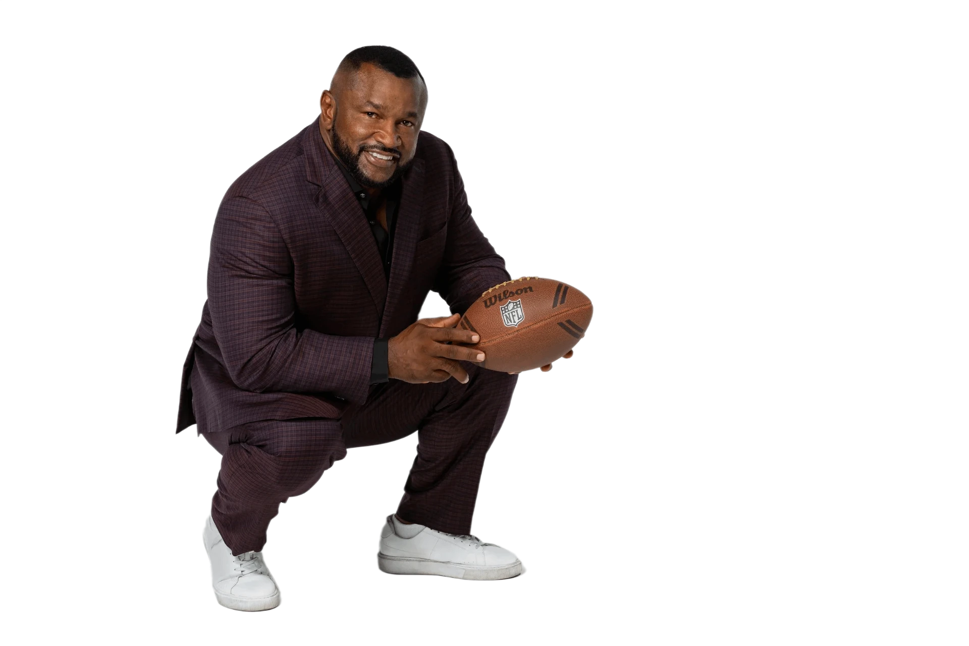 Lorenzo Neal crouching with a football