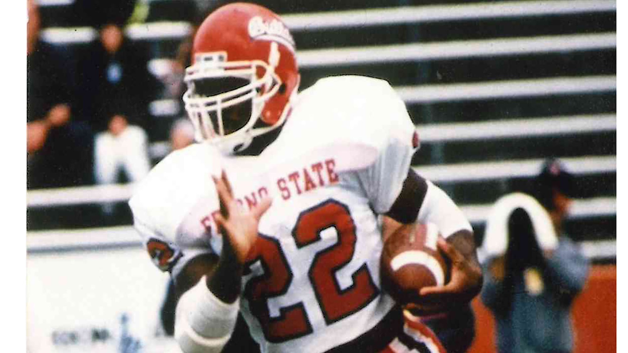 Lorenzo Neal wearing Fresno State’s No. 22 jersey and carrying the football